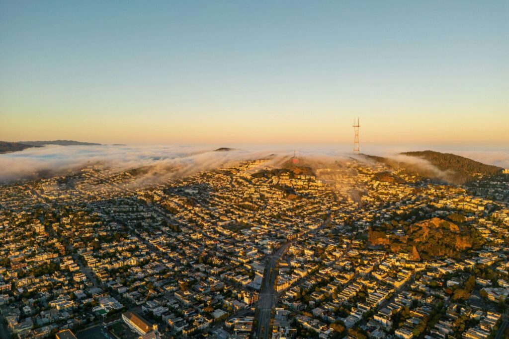 Aerial view of Culver City CA at sunset with hills and homes covered by coastal fog