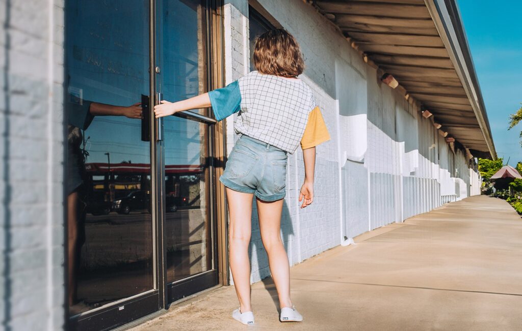 Person opening the front entrance door to a dentist office