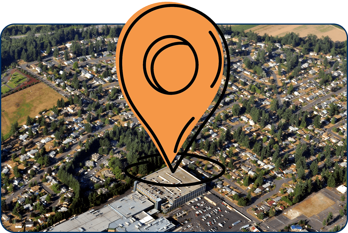 Large location pin icon on aerial view of Auburn, Washington with neighborhoods, tree-lined streets, and nearby shopping center