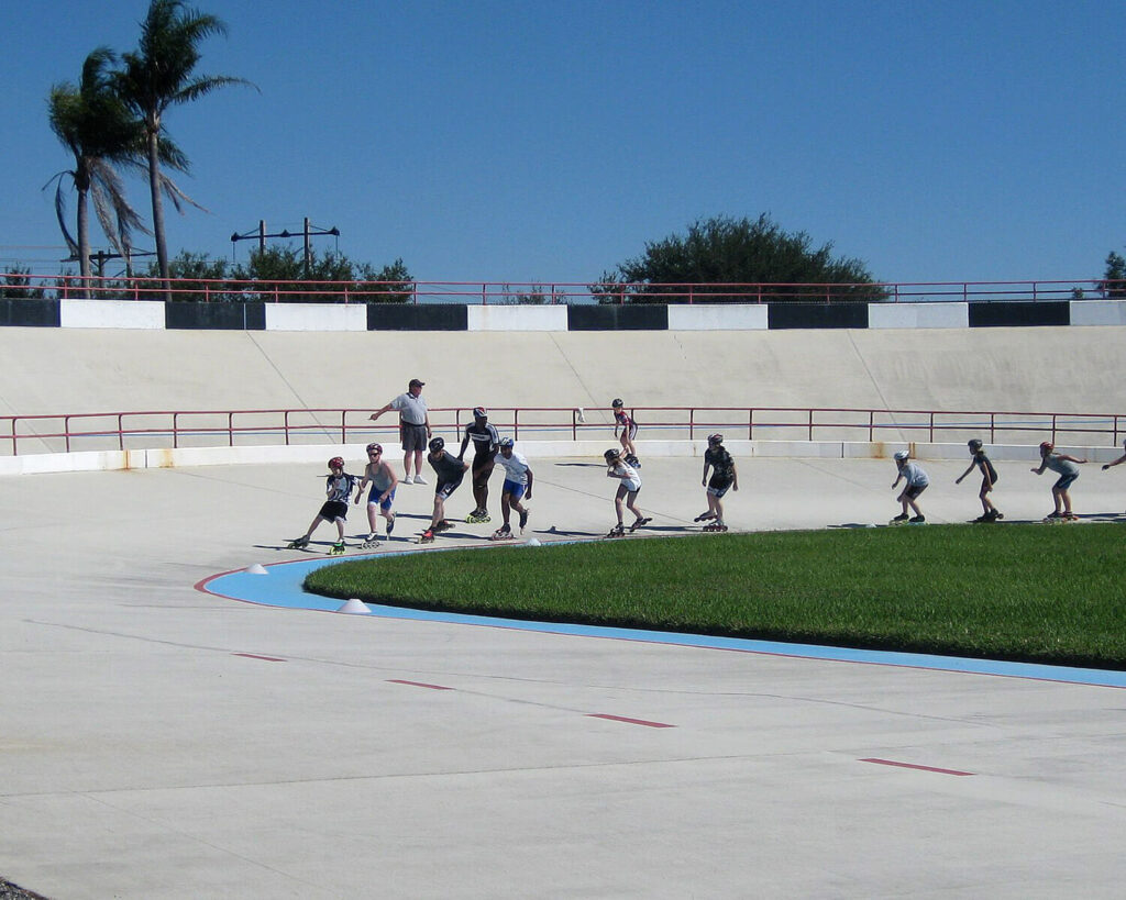 Inline speed skaters training at Brian Piccolo Park Velodrome in Cooper City, Florida on a sunny day