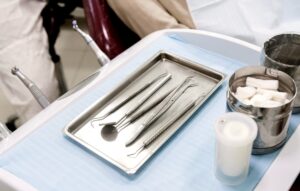 Dentist tray with dental instruments and gauze used for patient care