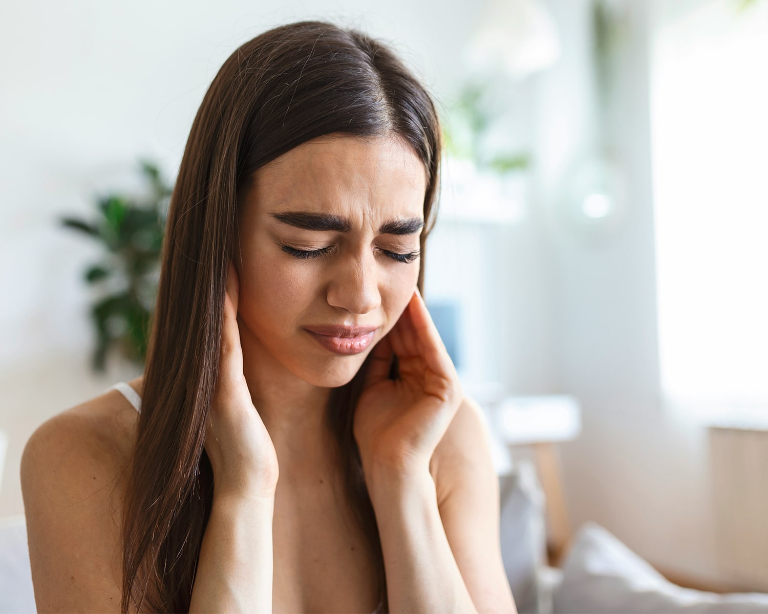 Patient with toothache holding jaw in pain