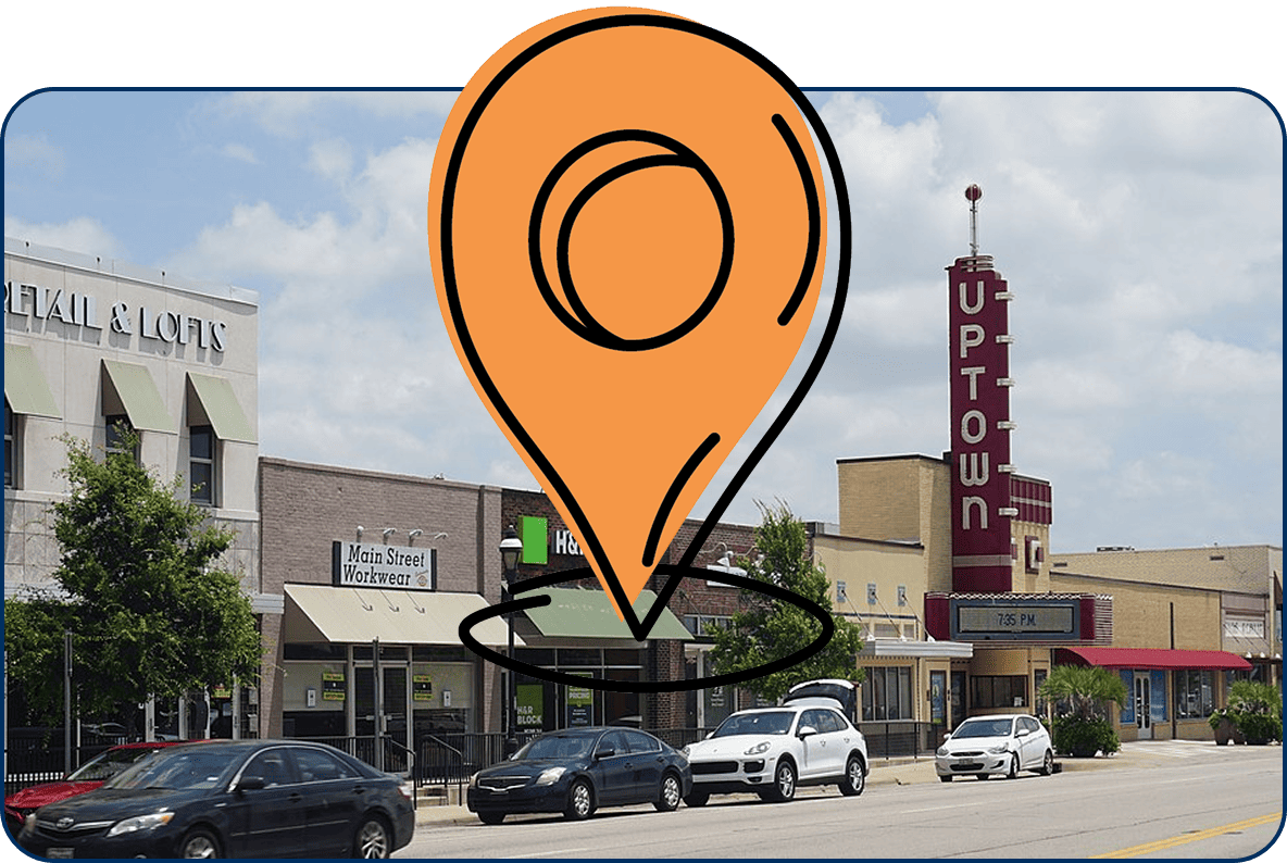 Large location pin icon on downtown Grand Prairie, TX on Main Street with Uptown Theater and local shops under a bright blue sky