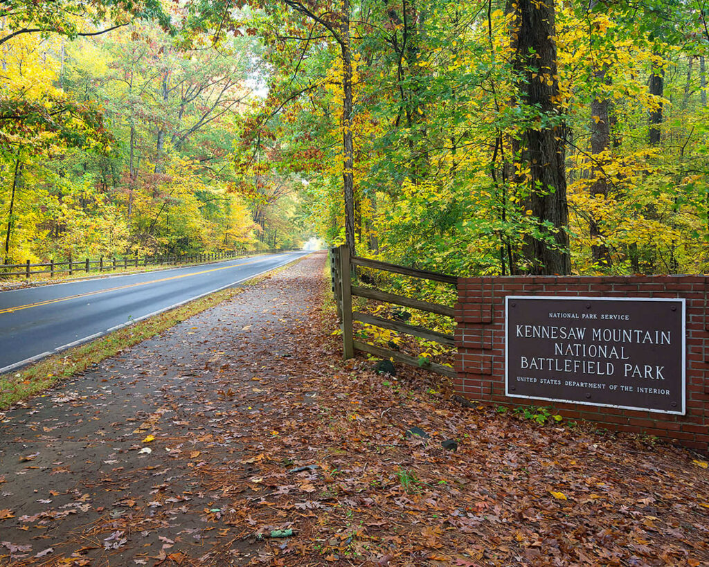 Entrance to Kennesaw Mountain National Battlefield Park with autumn leaves along the road