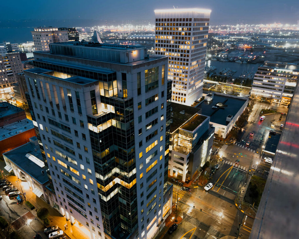 Downtown Tacoma, Washington at night with illuminated buildings and reflections from city lights
