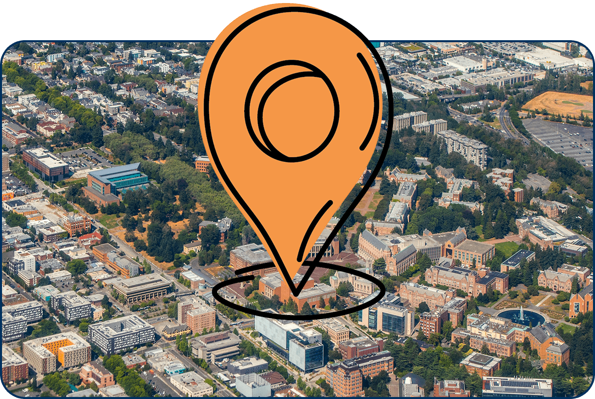 Large location pin icon on aerial view of downtown Tacoma, Washington with city buildings, parks, and surrounding neighborhoods