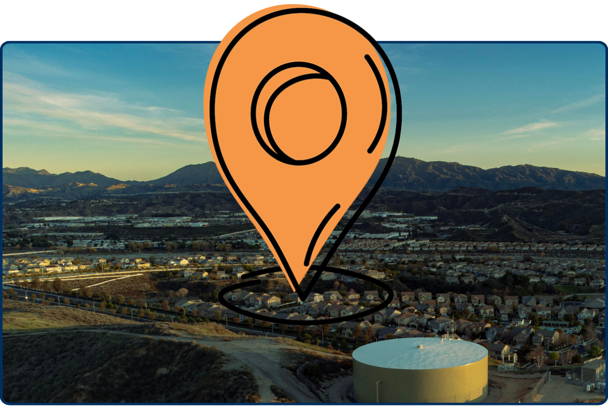Large location pin icon on aerial view of Valencia, California highlighting the community