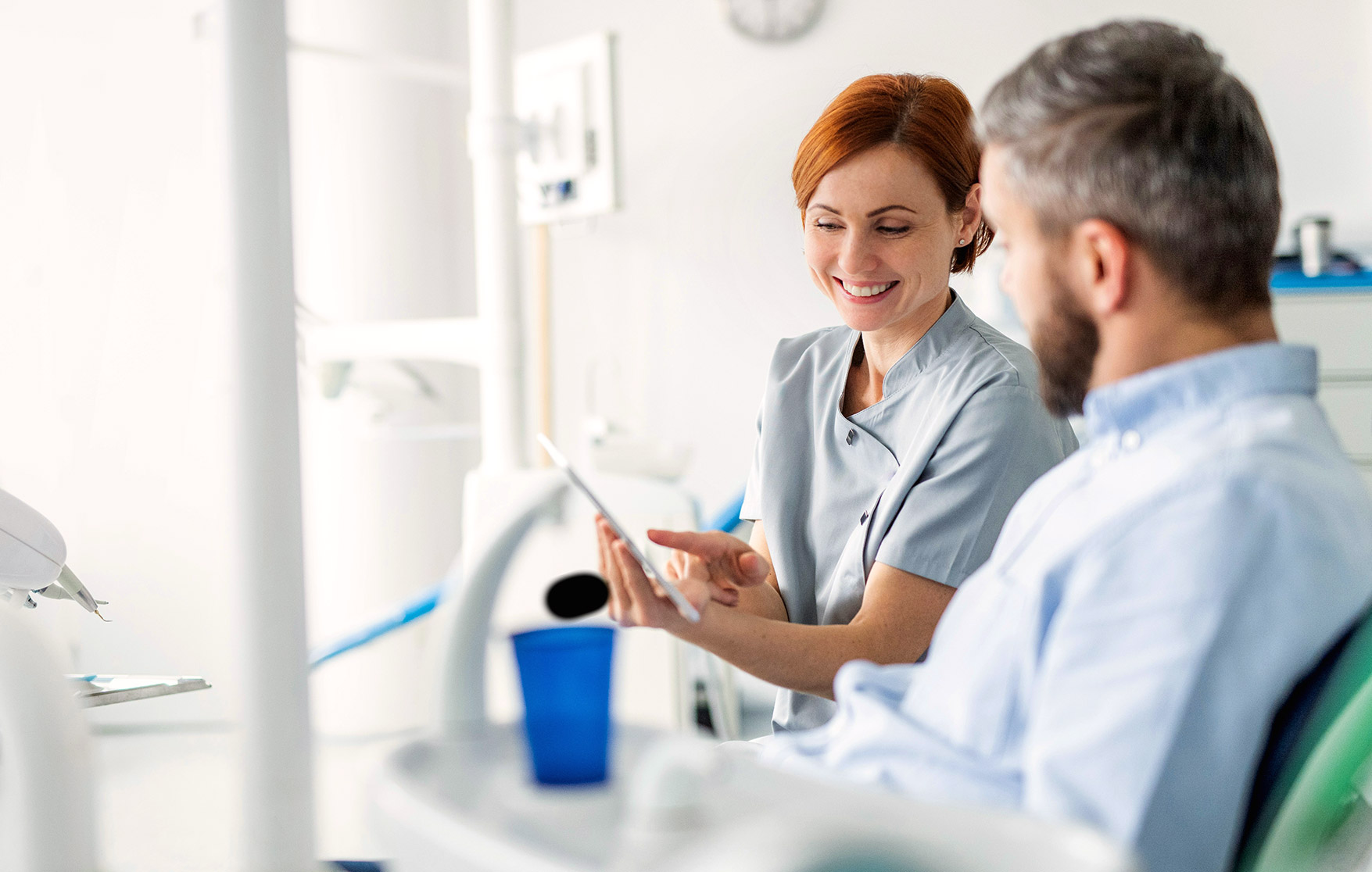 Dentist discussing tooth repair options with a patient during a consultation
