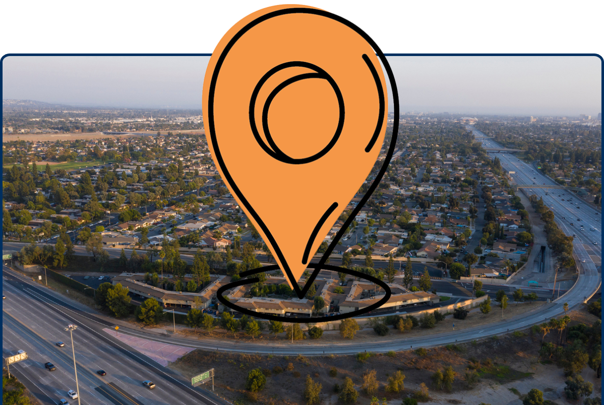 Aerial view of Anaheim, California showing suburban neighborhoods, highways, and a canal running through the city during golden hour