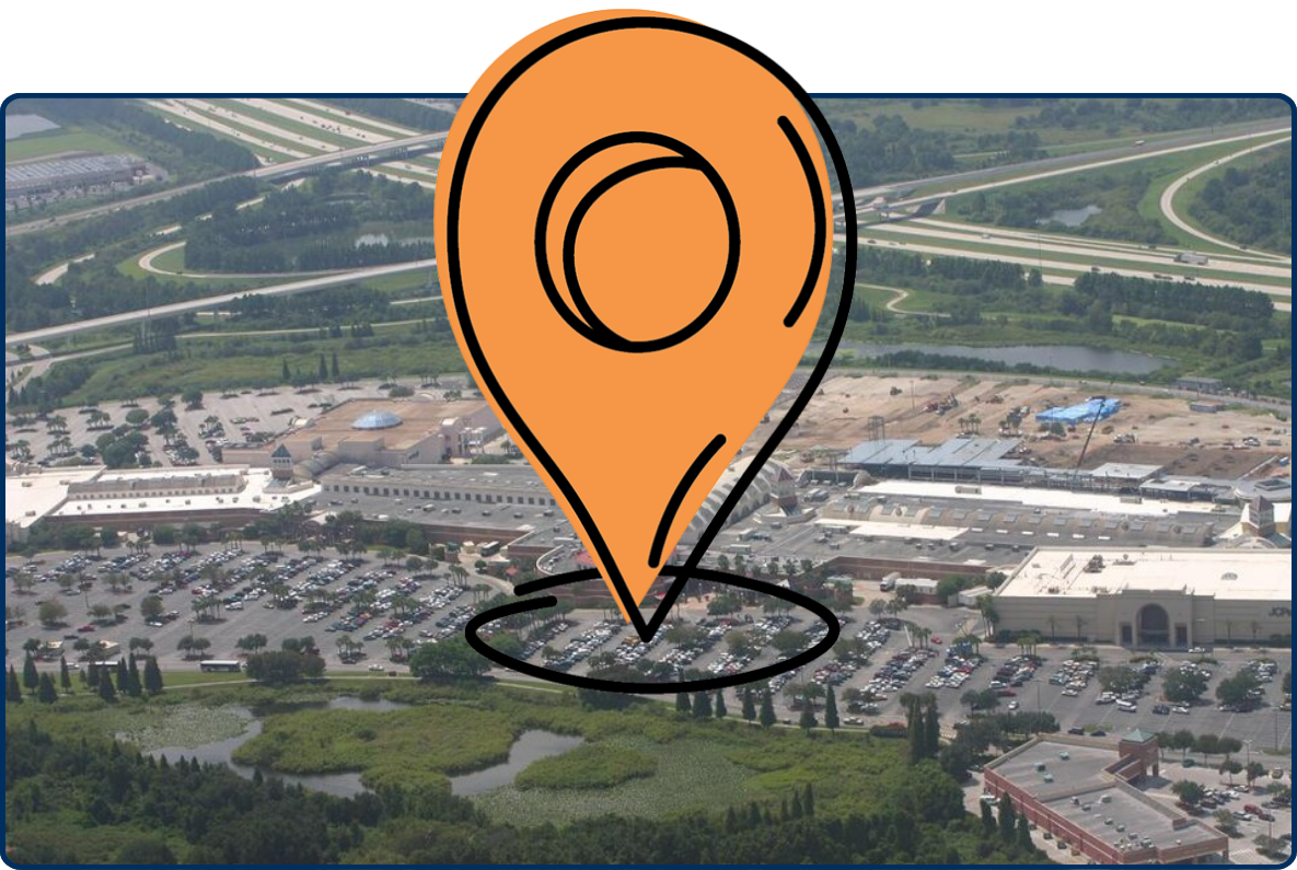 Aerial view of Brandon Mall in Brandon, Florida showing a large shopping complex, expansive parking lots filled with cars, and nearby highway intersections and greenery