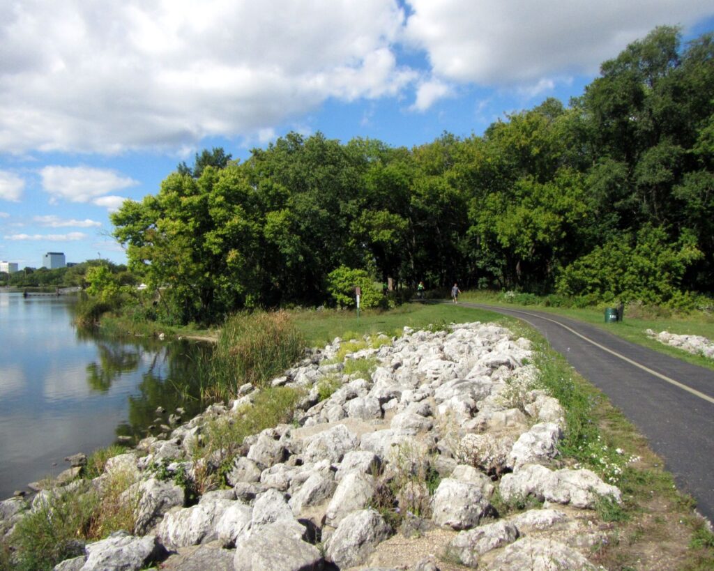 Busse Woods bicycle trail Illinois with lakeside path trees greenery and scenic outdoor nature view