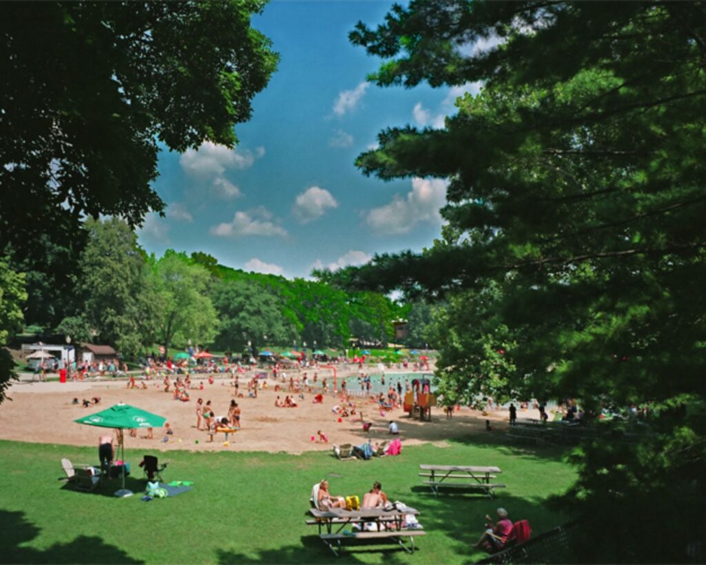Centennial Beach Illinois crowded summer scene with people swimming sandy shore greenery and outdoor recreation area