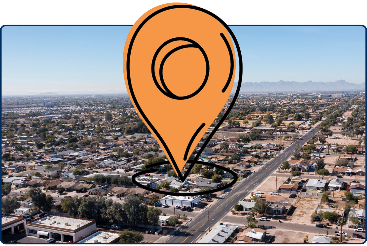 Aerial view of residential neighborhoods in Chandler Arizona with desert landscape, grid streets, low-rise homes and distant mountain range