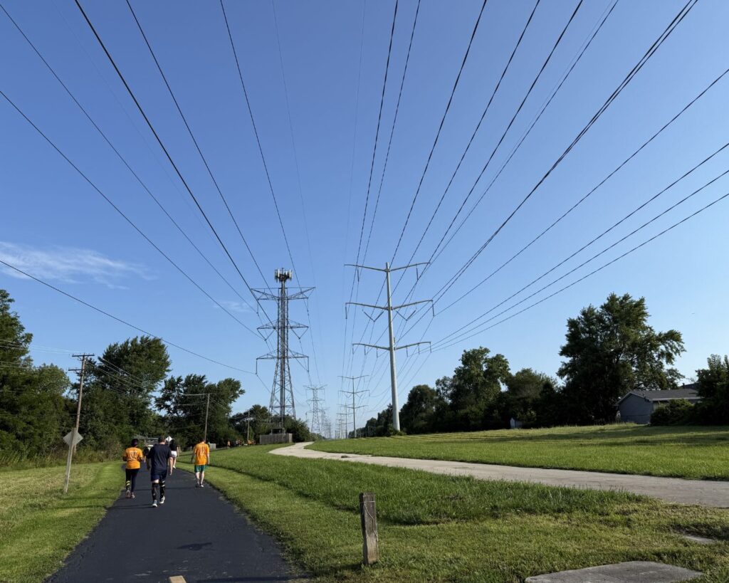 ComEd Greenway Trail Illinois walking path with people power lines towers blue sky green landscape outdoor recreation area USA