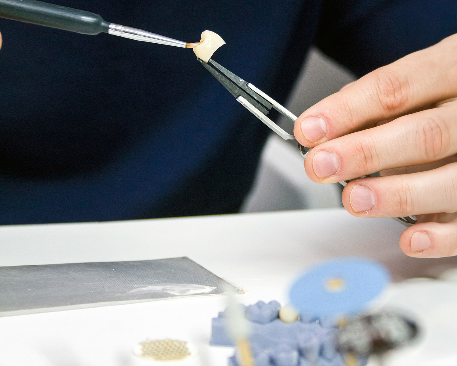 Dentist holding tooth using dental tools in clinic
