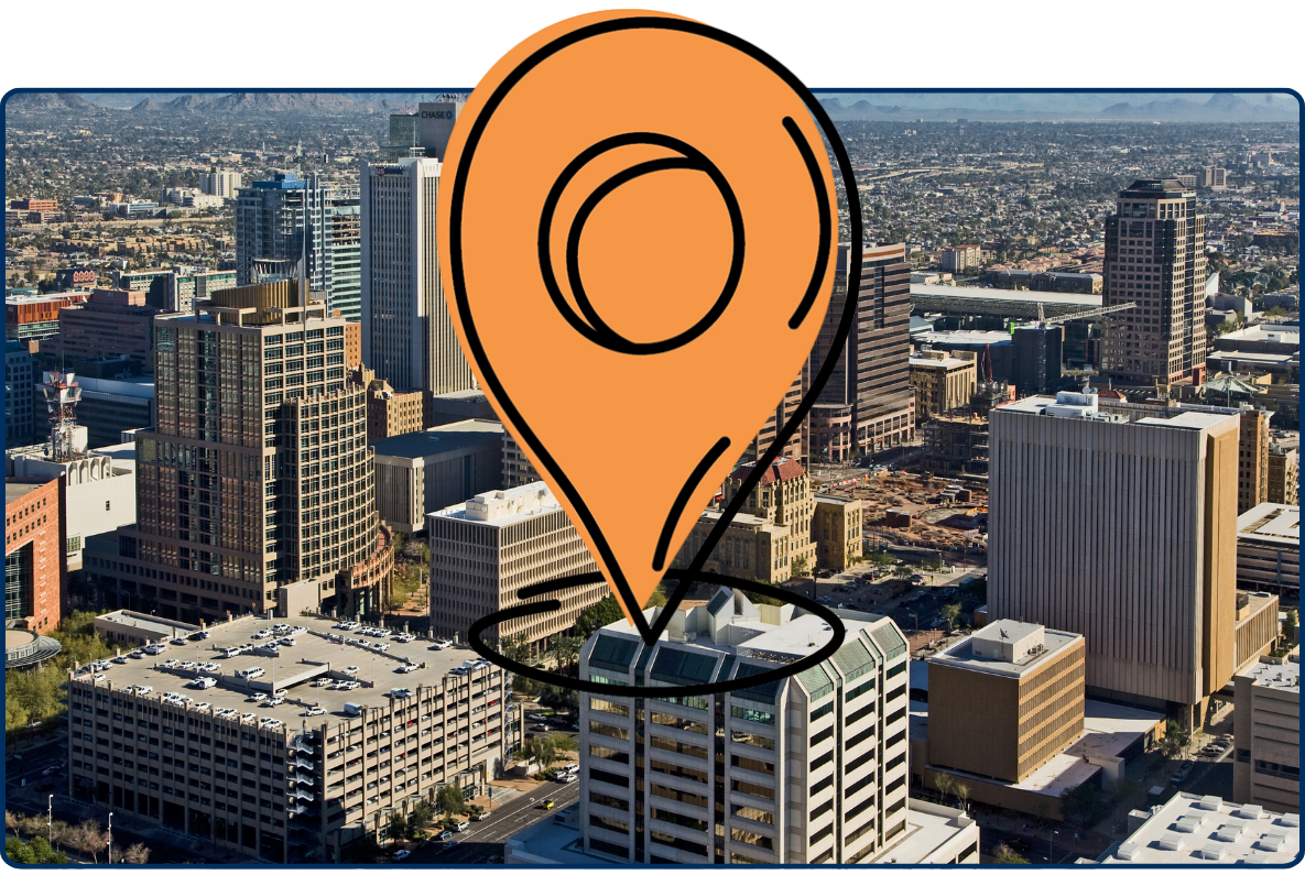 Aerial view of downtown Phoenix, Arizona with high-rise buildings and surrounding desert landscape and mountains in the distance
