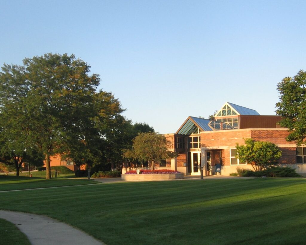 North Riverside Illinois Commons building with green lawn modern architecture and trees during sunny day