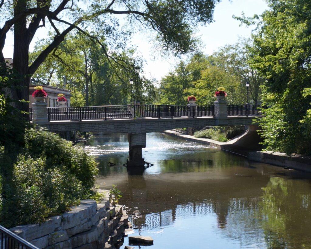 Naperville Riverwalk Illinois scenic river bridge trees walkway peaceful downtown park water reflection urban nature USA