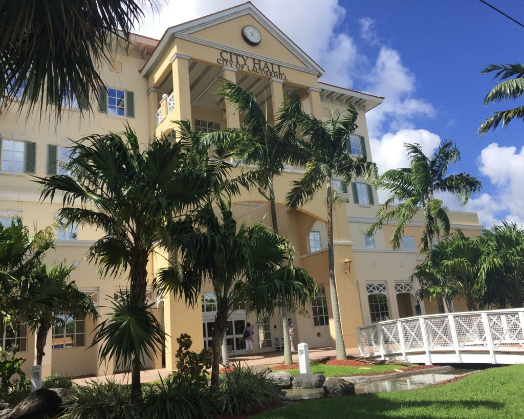Lauderhill City Hall Florida building with palm trees entrance walkway and blue sky exterior architecture
