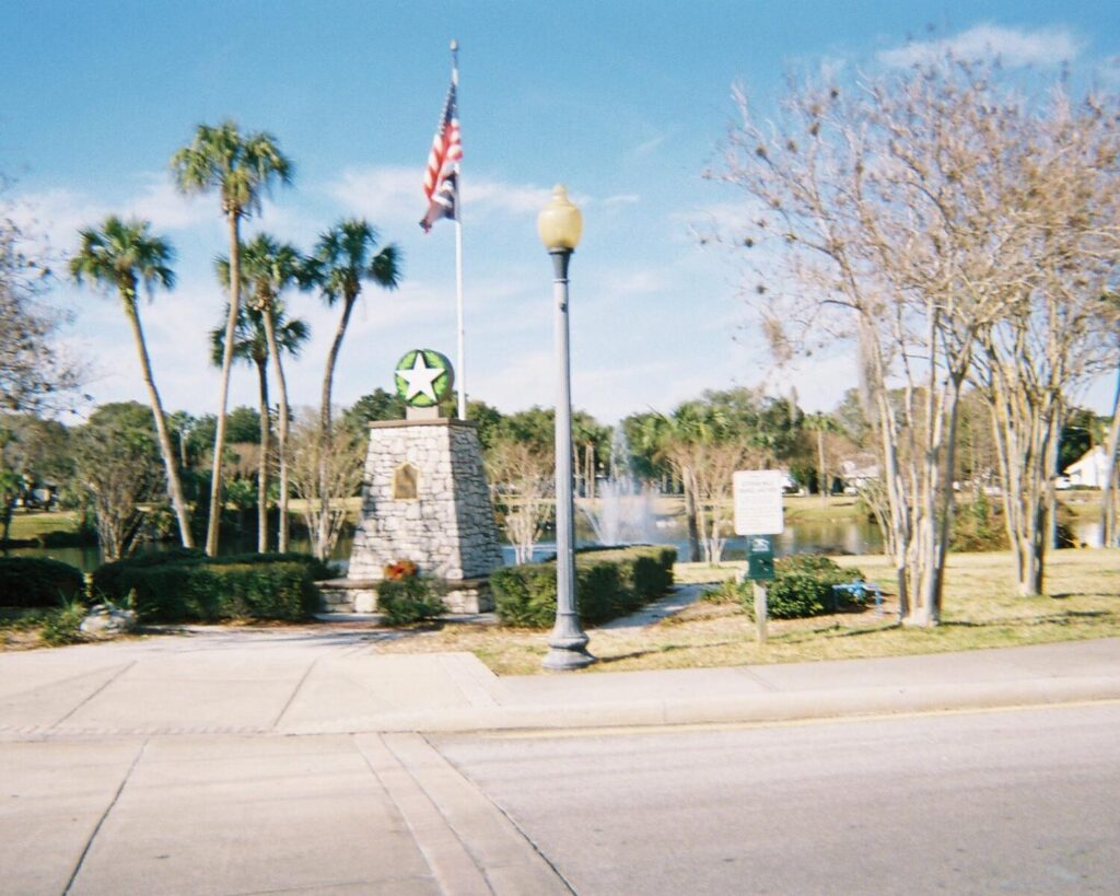 Orange Lake War Memorial New Port Richey Florida monument with American flag park trees lake background historic memorial USA