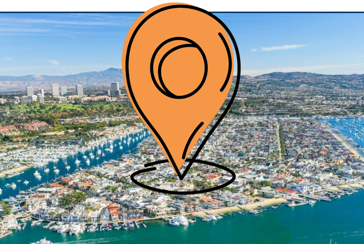 Aerial view of Newport Beach harbor with multiple sailboats on turquoise water and a densely built coastal neighborhood in the background