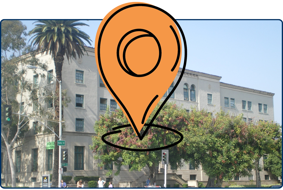 Pasadena YMCA Centennial Place building with historic architecture, palm tree, and pedestrians in Pasadena California