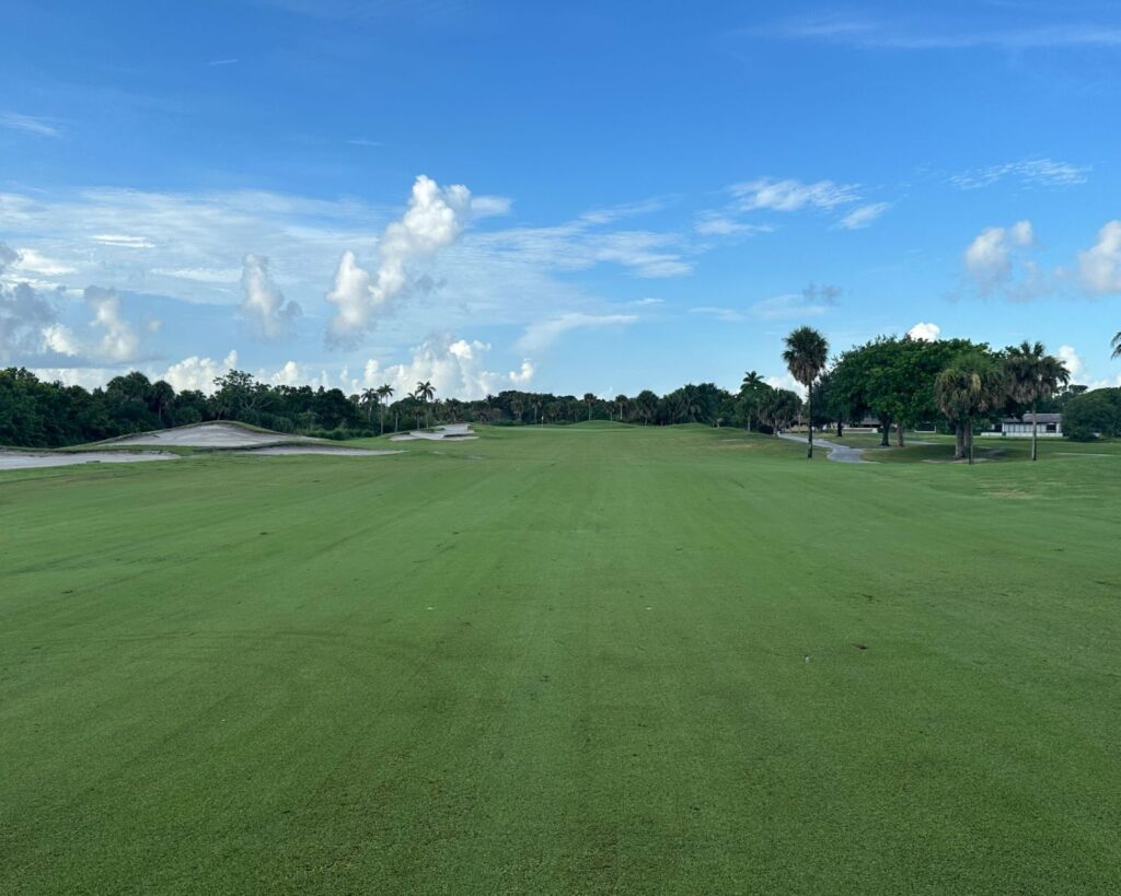 Plantation Preserve Golf Course and Club Florida with green fairway trees open landscape and blue sky with clouds