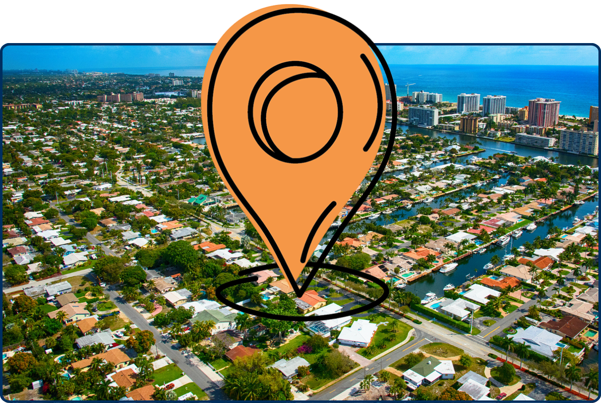 Aerial view of Pompano Beach, Florida showing residential neighborhoods, canals, high-rise buildings, and the Atlantic Ocean coastline under a partly cloudy sky