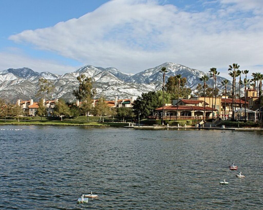 Lago Santa Margarita with scenic lake view, palm trees, and snow-covered mountains in Rancho Santa Margarita, California