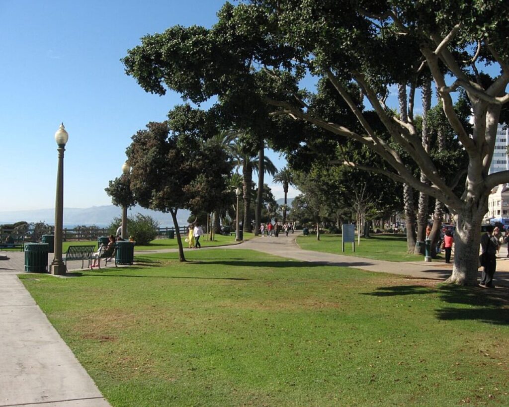 Palisades Park with ocean view, walking paths, trees, and grassy area in Santa Monica, California