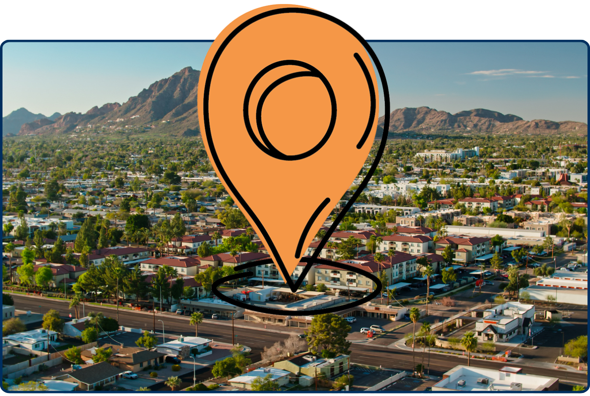 Aerial view of homes in Scottsdale Arizona with residential neighborhoods, desert city streets, palm trees and mountain backdrop