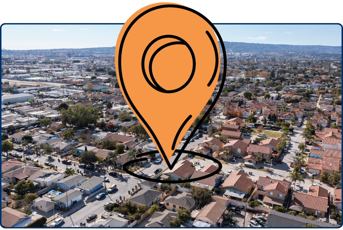 Aerial view of Wilmington California residential neighborhood with houses streets and cityscape under clear sky