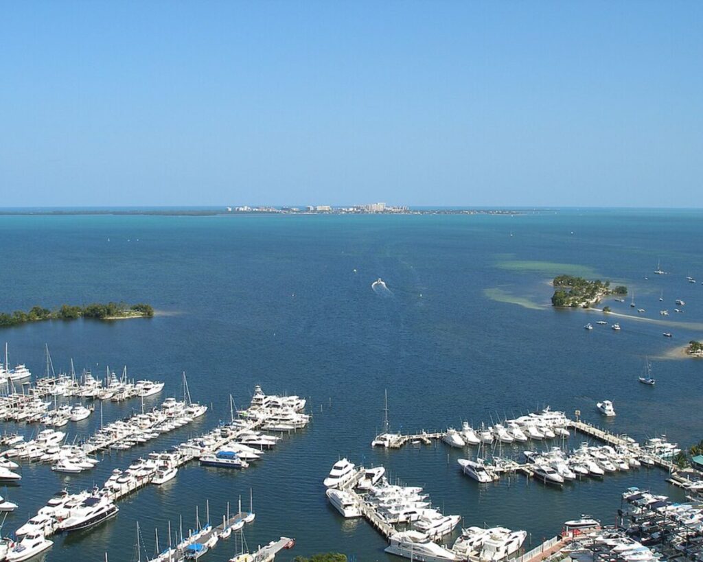 View across Biscayne Bay from Coconut Grove Marina toward Key Biscayne with boats and blue water.