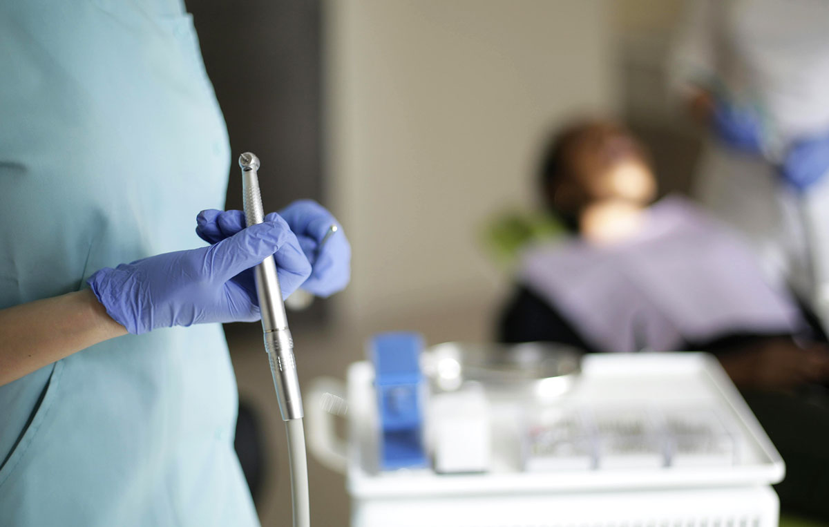 Dentist holding dental tool in clinic preparing for patient treatment and oral health procedure