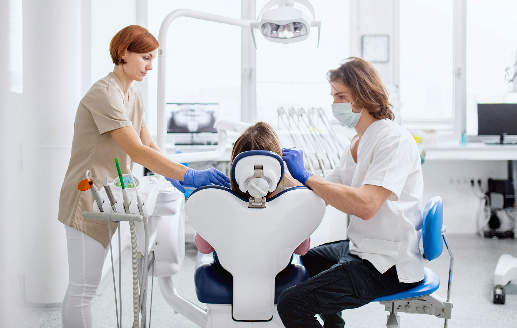 Dentist treating patient in modern dental clinic during emergency tooth abscess examination