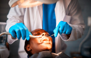 Dentist performing dental procedure on patient during root canal treatment with professional dental tools and care