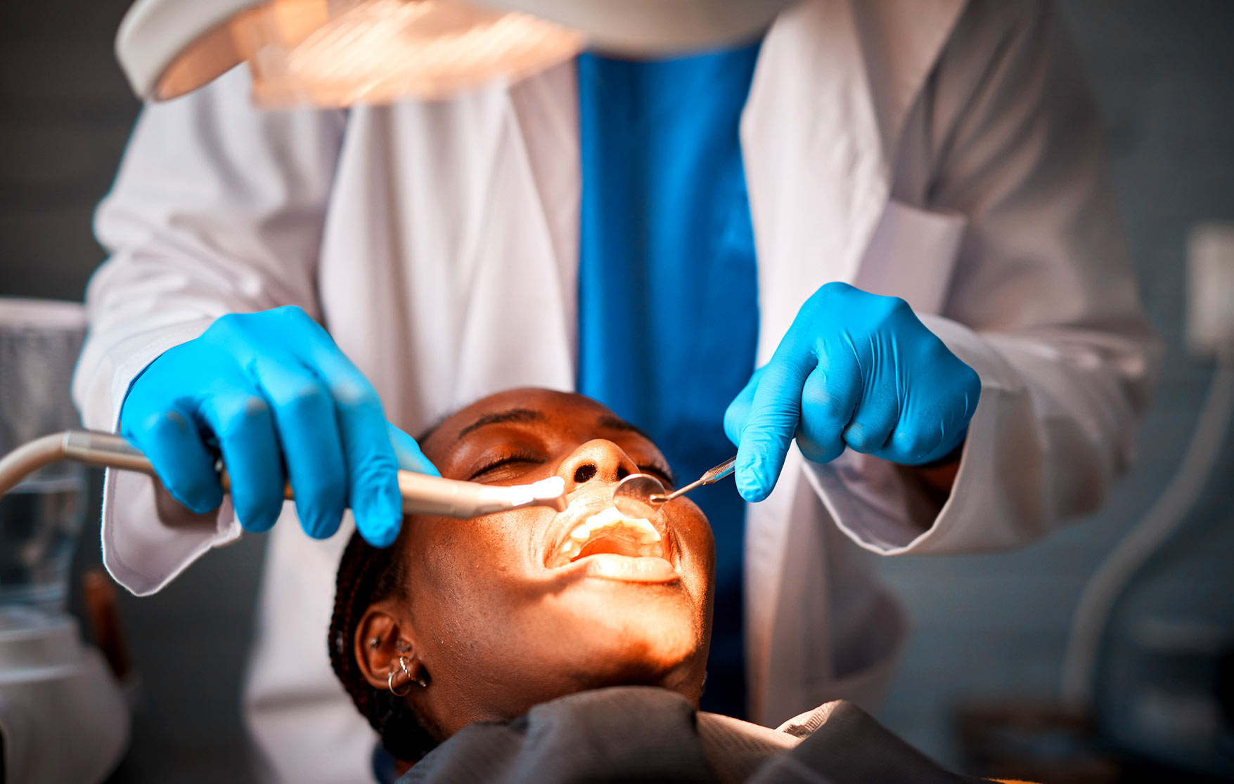 Dentist performing dental procedure on patient during root canal treatment with professional dental tools and care