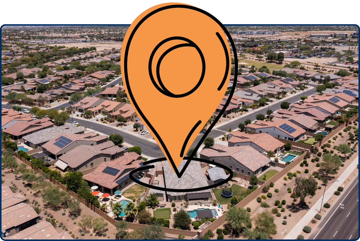 Aerial view of a suburban neighborhood in Goodyear, Arizona, featuring rows of desert-style homes, curved streets, and solar panels on rooftops.