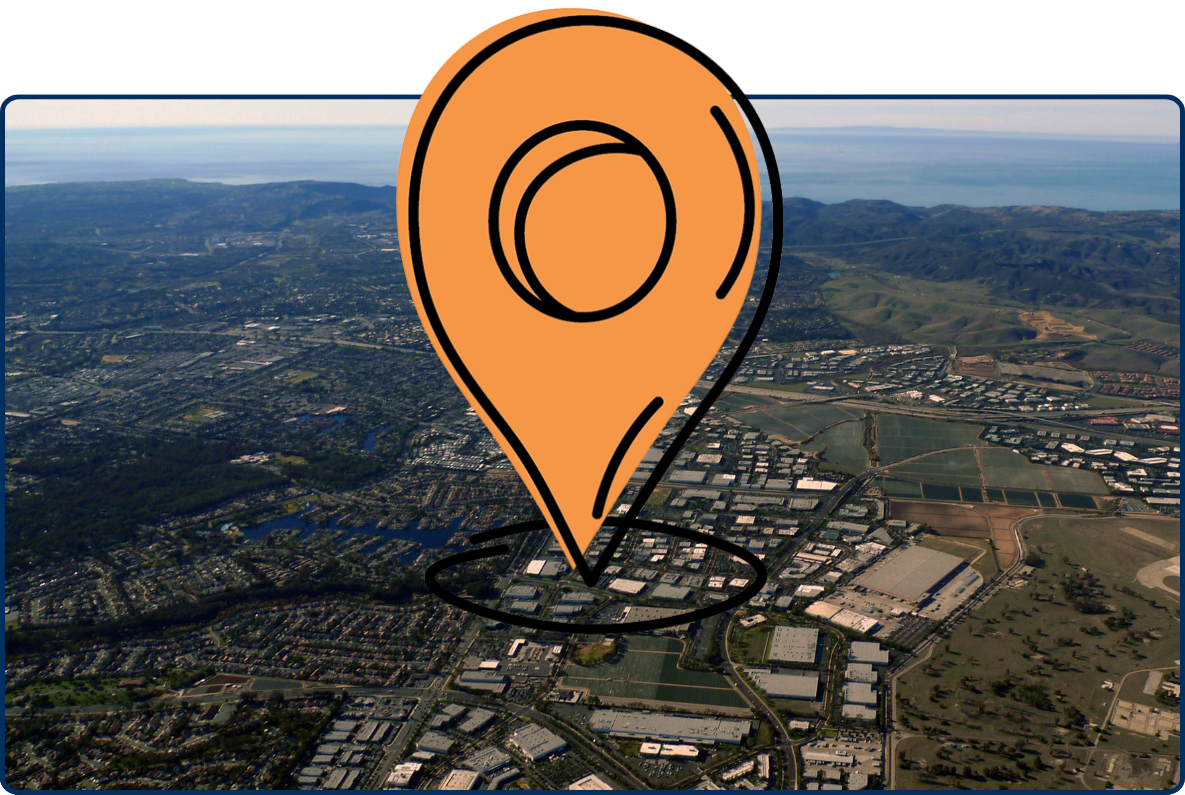 Aerial view of Lake Forest and Laguna Hills showing residential areas, roads, hills, and coastline in the distance.
