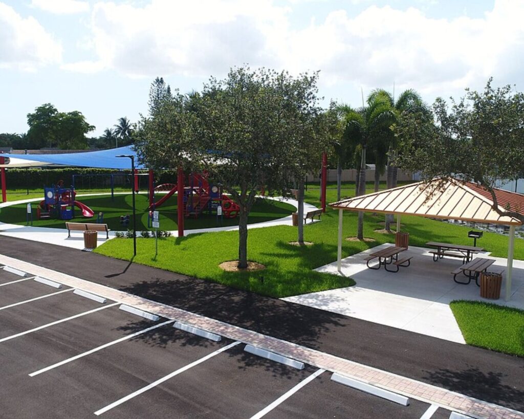 Margate Serino Park playground with shaded play area, picnic pavilion, and surrounding greenery.