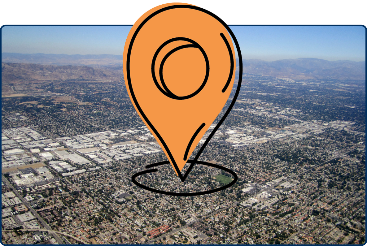 Aerial view of Northridge, Los Angeles, showing dense residential neighborhoods, industrial areas, and surrounding mountain ranges.