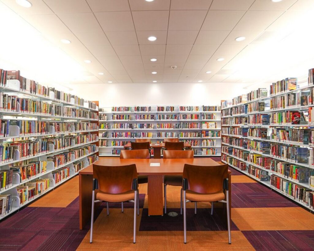 Stevenson Ranch Library interior with bookshelves, reading tables, and chairs in a bright study area.