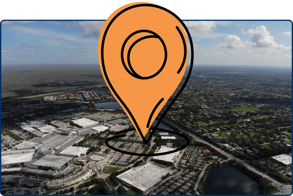 Aerial view of Sunrise, Florida, showing sprawling neighborhoods, shopping centers, roads, and lakes beneath a partly cloudy sky.