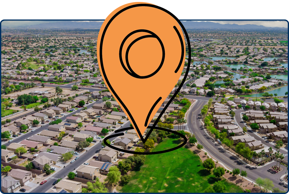 Aerial view of Avondale, Arizona neighborhood with small ponds, homes, roads, and cloudy sky.
