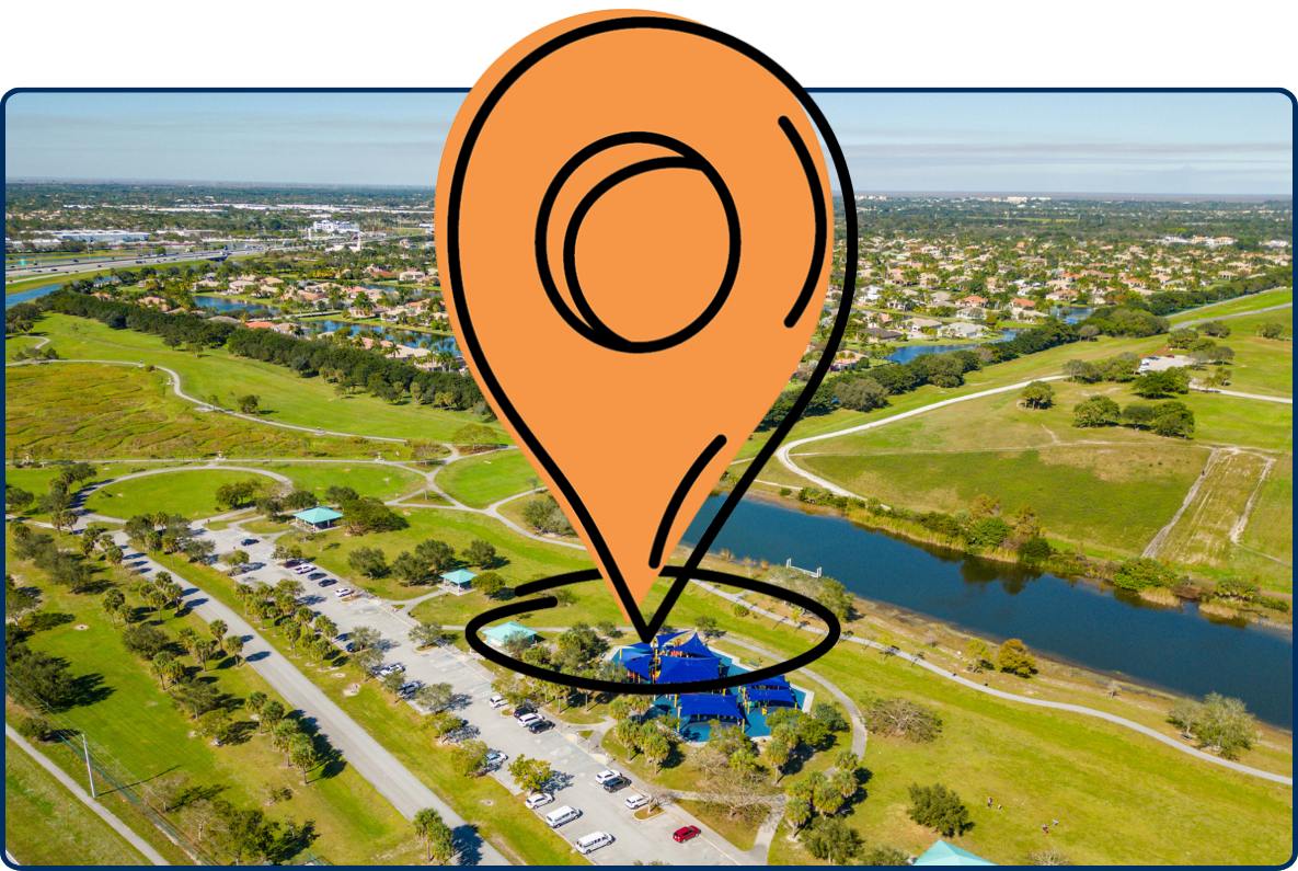 Aerial view of Vista View Park in Davie, Florida with green fields, lake, paths, and nearby neighborhoods.
