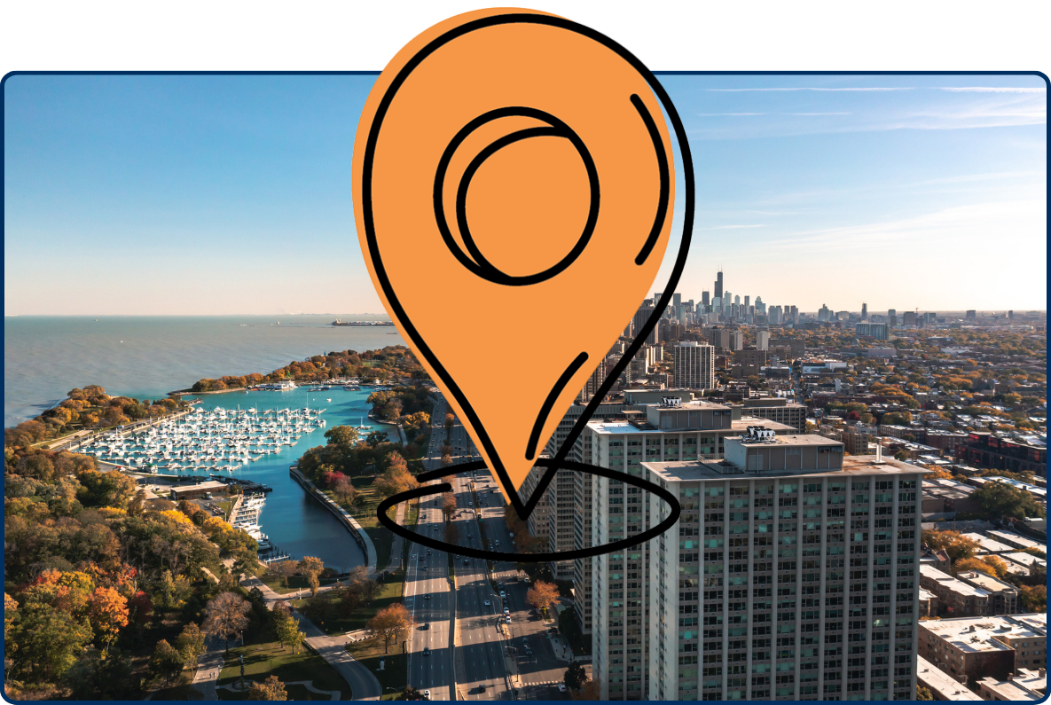 Aerial view of downtown Chicago with Lake Michigan, Belmont Harbor, high-rise buildings, and Lake Shore Drive on a sunny day.