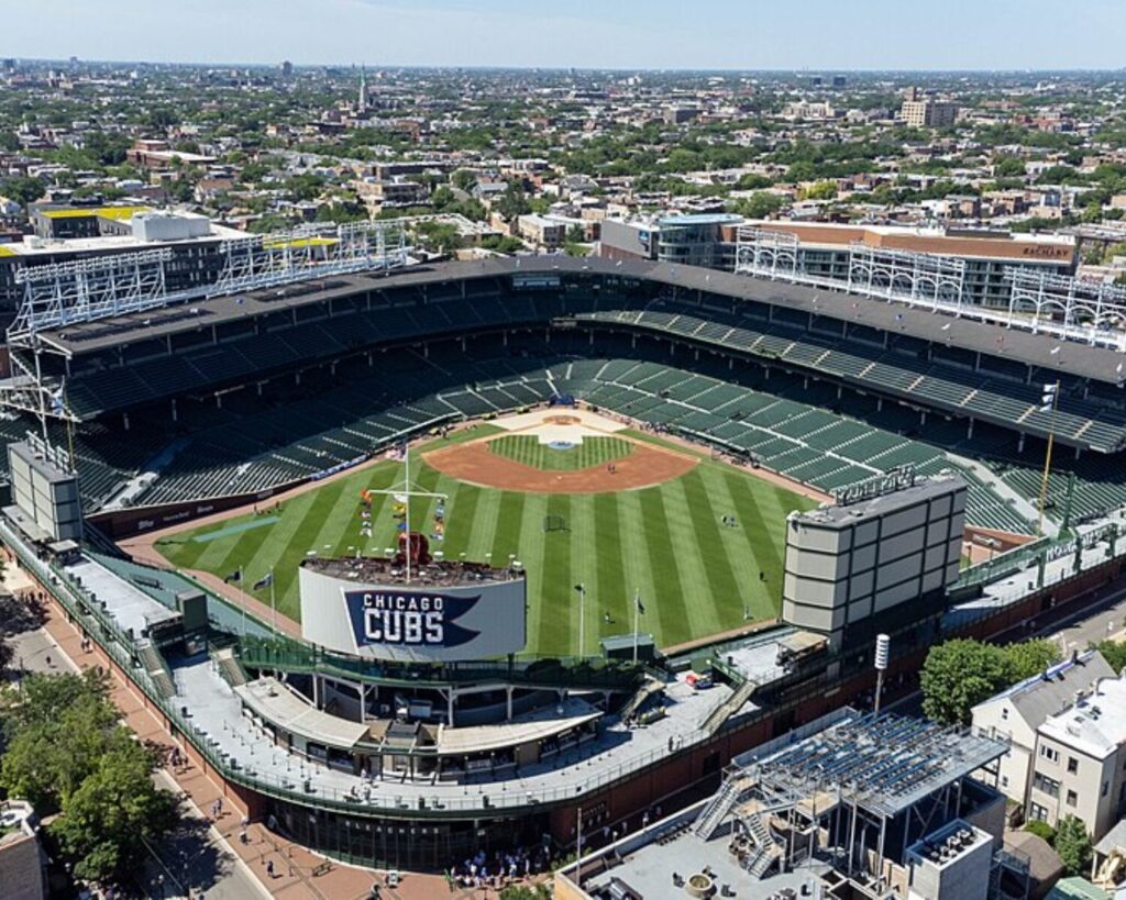 Aerial view of Wrigley Field baseball stadium in Chicago with surrounding city neighborhoods.
