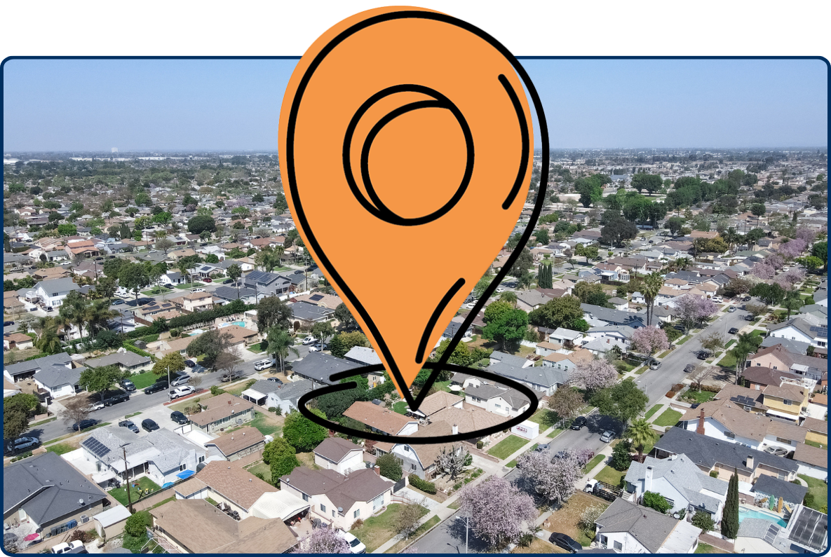 Aerial view of Lakewood neighborhood in Los Angeles County with suburban homes and clear blue sky.