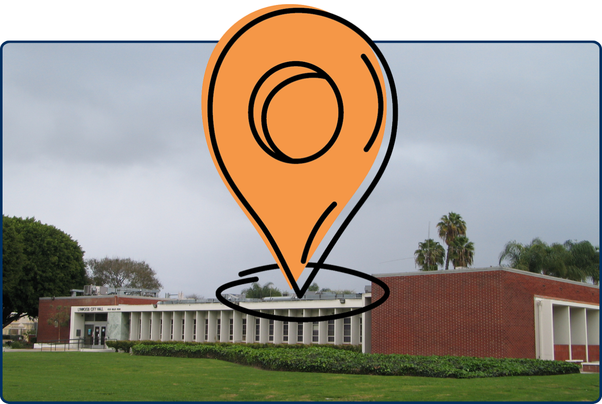 Lynwood City Hall exterior with green lawn, brick building, palm trees, and cloudy sky.