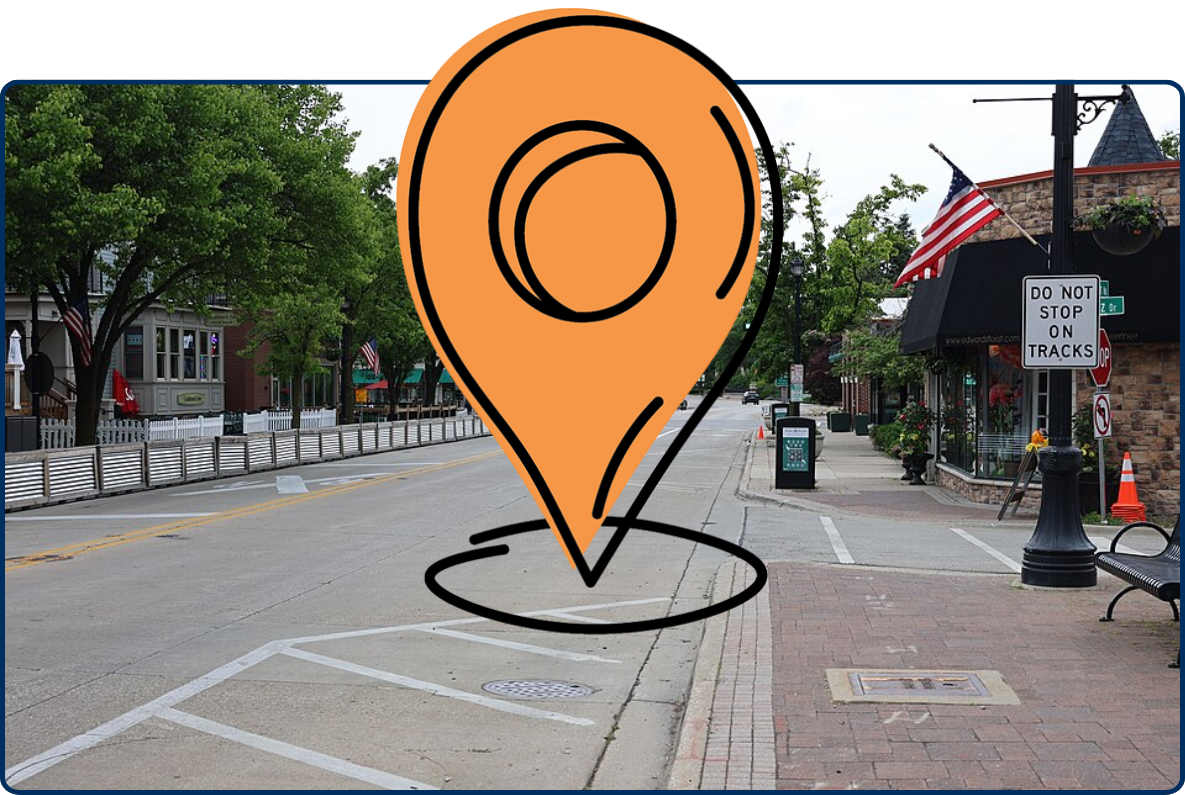 Downtown Northbrook, Illinois street view with shops, sidewalks, trees, and American flags.